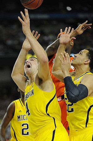 Caris LeVert (23), Mitch McGary (4), and Jordan Morgan (52)
