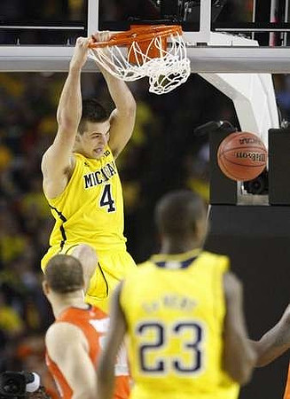 Mitch McGary (4) and Caris LeVert (23)