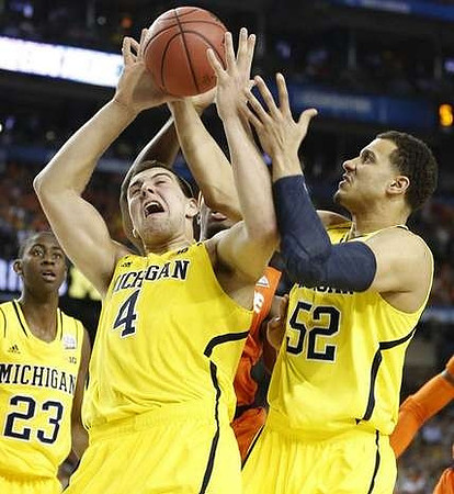 Caris LeVert (23), Mitch McGary (4), and Jordan Morgan (52)