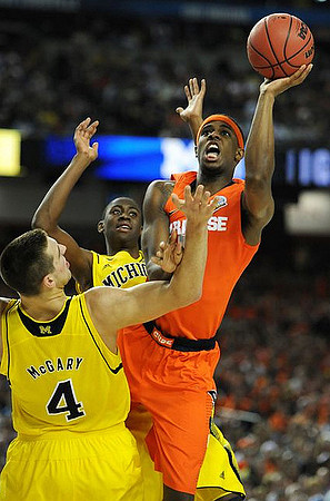 Mitch McGary (4) and Caris LeVert (23)