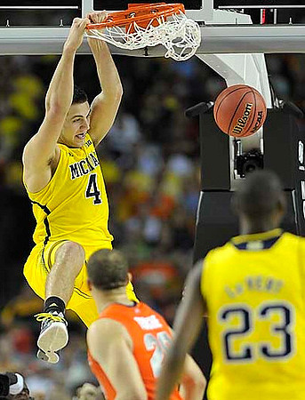 Mitch McGary (4) and Caris LeVert (23)