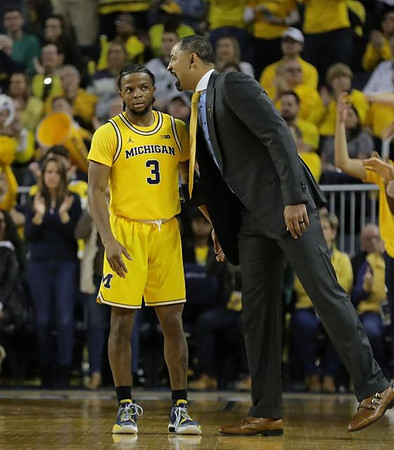 Zavier Simpson (3) and Juwan Howard
