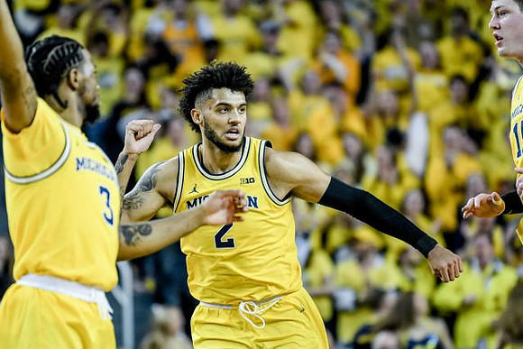 Zavier Simpson (3), Isaiah Livers (2), and Jon Teske (15)