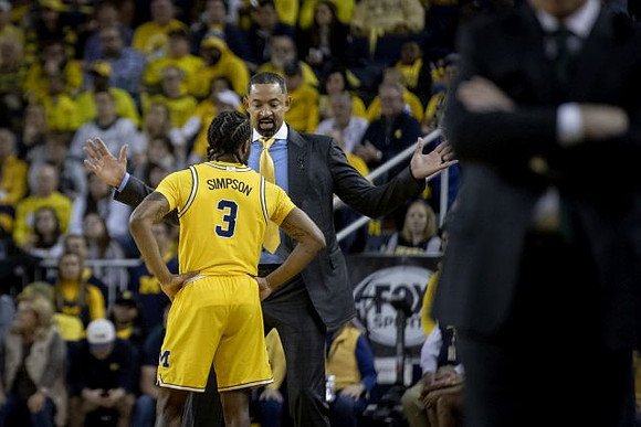 Zavier Simpson (3) and Juwan Howard