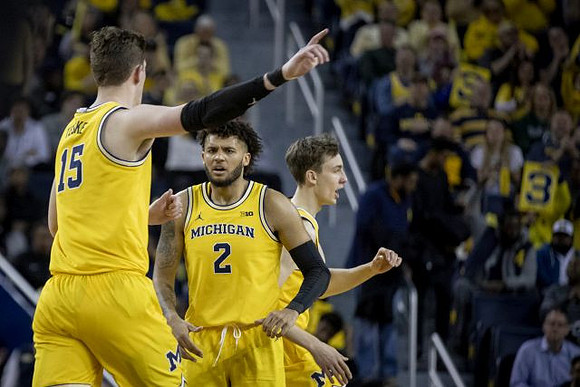 Jon Teske (15), Isaiah Livers (2), and Franz Wagner (21)