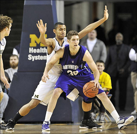 Zack Novak (0) and Jon Horford (15)