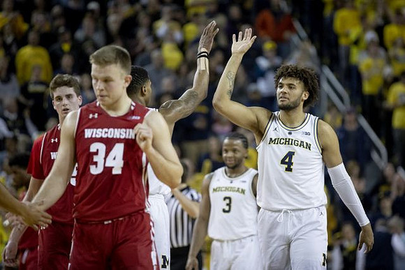 Charles Matthews (1), Zavier Simpson (3), and Isaiah Livers (4)