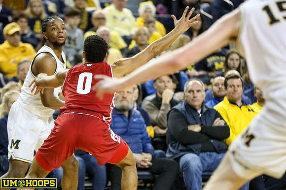 Zavier Simpson (3) and Jon Teske (15)