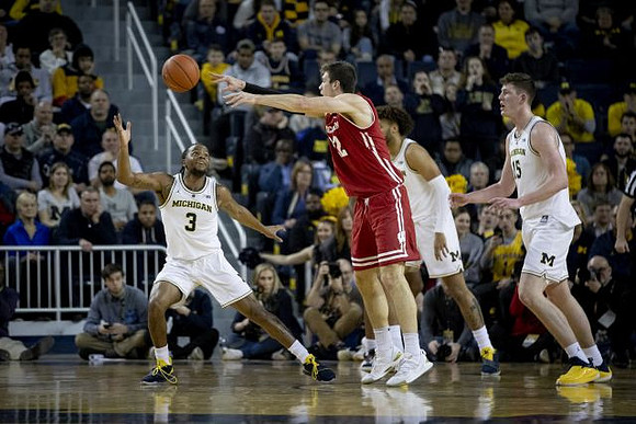 Zavier Simpson (3), Isaiah Livers (4), and Jon Teske (15)
