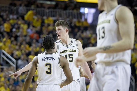 Zavier Simpson (3), Jon Teske (15), and Ignas Brazdeikis (13)