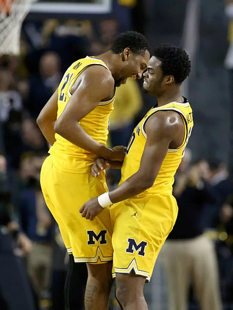 Zak Irvin (21) and Derrick Walton Jr. (10)