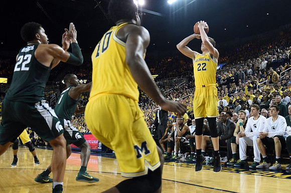 Duncan Robinson (22) and Derrick Walton Jr. (10)