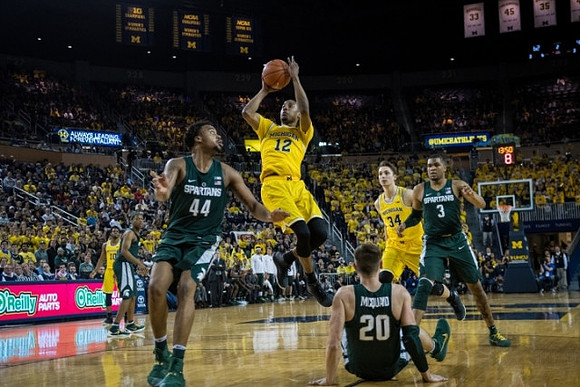 Derrick Walton Jr. (10), Muhammad-Ali Abdur-Rahkman (12), and Mark Donnal (34)