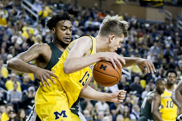Moritz Wagner (13) and Derrick Walton Jr. (10)