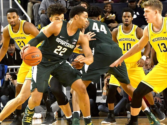 Zak Irvin (21), D.J. Wilson (5), Derrick Walton Jr. (10), and Moritz Wagner (13)