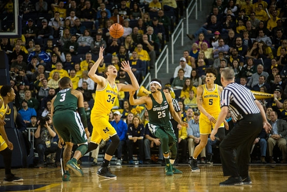 Zak Irvin (21), Mark Donnal (34), and D.J. Wilson (5)