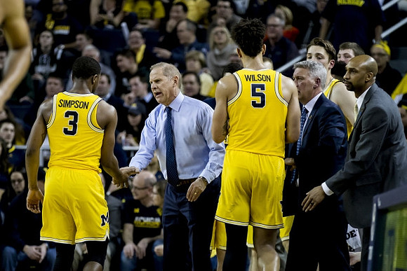 Xavier Simpson (3), John Beilein, D.J. Wilson (5), Jeff Meyer, Mark Donnal (34), and Saddi Washington