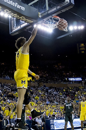 D.J. Wilson (5) and Zak Irvin (21)