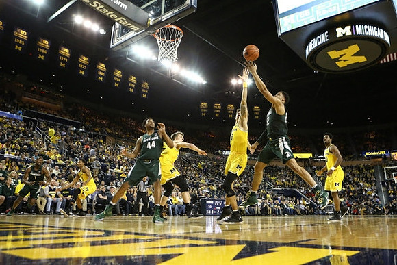 Zak Irvin (21), Moritz Wagner (13), D.J. Wilson (5), and Derrick Walton Jr. (10)