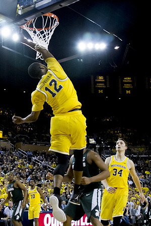 Muhammad-Ali Abdur-Rahkman (12), Derrick Walton Jr. (10), and Mark Donnal (34)