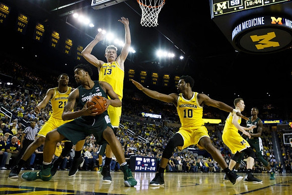 Zak Irvin (21), Moritz Wagner (13), Derrick Walton Jr. (10), and Duncan Robinson (22)