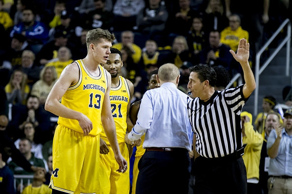 Moritz Wagner (13), Zak Irvin (21), and John Beilein