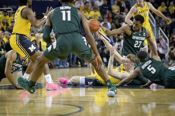 Zavier Simpson (3), Ignas Brazdeikis (13), and Jon Teske (15)