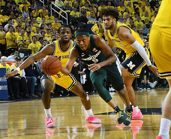 Zavier Simpson (3) and Isaiah Livers (4)