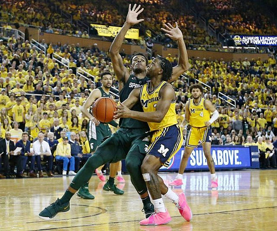 Zavier Simpson (3) and Isaiah Livers (4)