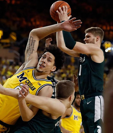 Brandon Johns Jr. (23) and Isaiah Livers (4)