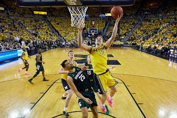 Zavier Simpson (3), Jon Teske (15), and Ignas Brazdeikis (13)