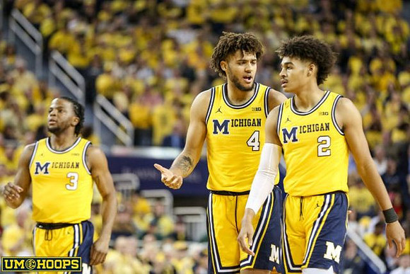 Zavier Simpson (3), Isaiah Livers (4), and Jordan Poole (2)