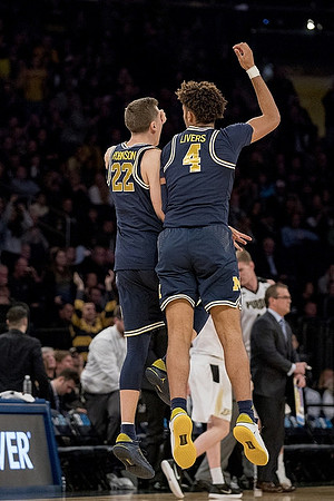 Duncan Robinson (22) and Isaiah Livers (4)