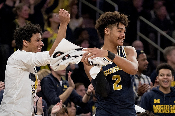Eli Brooks (55) and Jordan Poole (2)