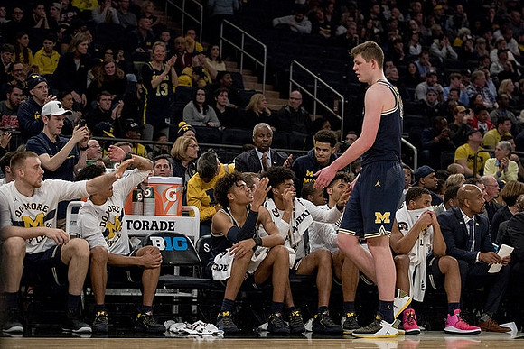 Jon Teske (15) and Michigan Team