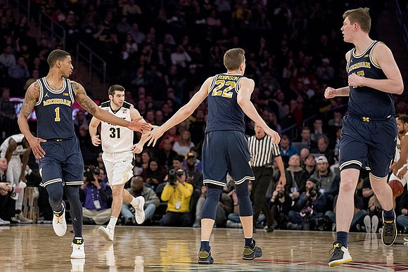 Charles Matthews (1), Duncan Robinson (22), and Jon Teske (15)