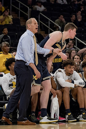 Ibi Watson (23), John Beilein, Jon Teske (15), and Isaiah Livers (4)