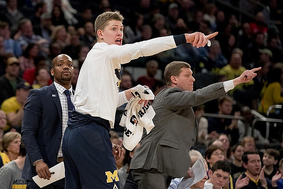 Deandre Haynes, Moritz Wagner (13), and Luke Yaklich