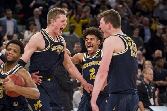 Zavier Simpson (3), Moritz Wagner (13), Jordan Poole (2), and Jon Teske (15)