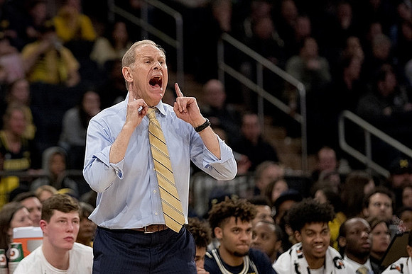 Jon Teske (15), John Beilein, Isaiah Livers (4), and Ibi Watson (23)