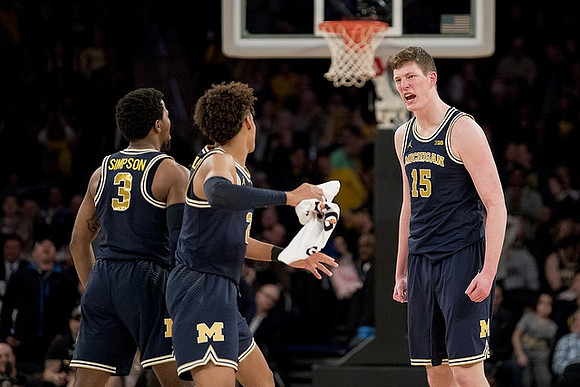 Zavier Simpson (3), Jordan Poole (2), and Jon Teske (15)