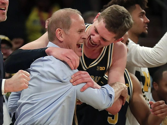 John Beilein, Moritz Wagner (13), and Isaiah Livers (4)