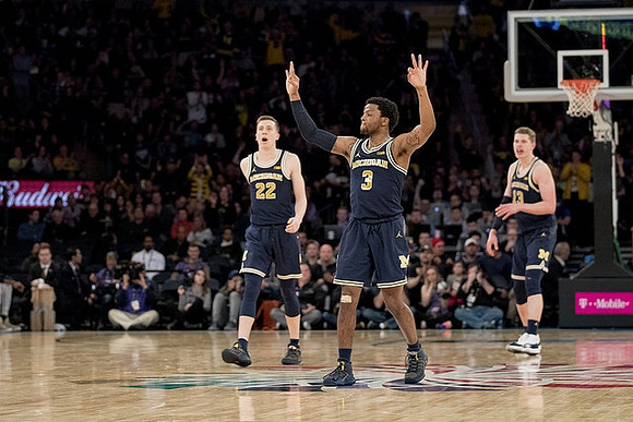 Duncan Robinson (22), Zavier Simpson (3), and Moritz Wagner (13)