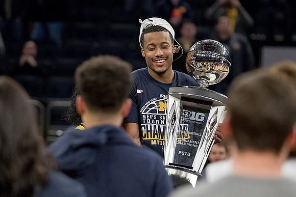 Muhammad-Ali Abdur-Rahkman (12) and Big Ten Tournament Trophy