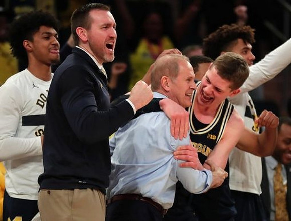 Ibi Watson (23), John Beilein, Moritz Wagner (13), and Isaiah Livers (4)