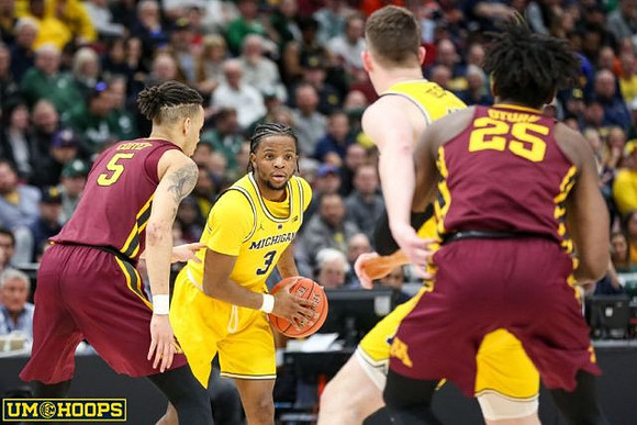 Zavier Simpson (3) and Jon Teske (15)