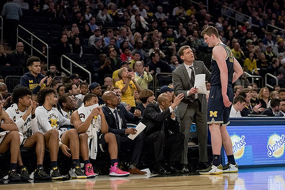 Luke Yaklich, Jon Teske (15), and Michigan Team