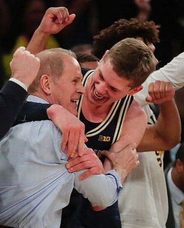 John Beilein, Moritz Wagner (13), and Isaiah Livers (4)