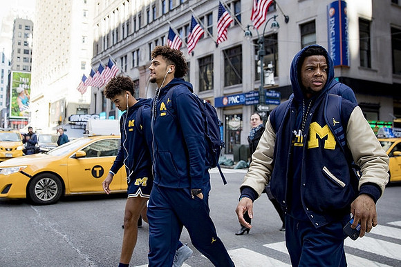 Jordan Poole (2), Isaiah Livers (4), and Zavier Simpson (3)