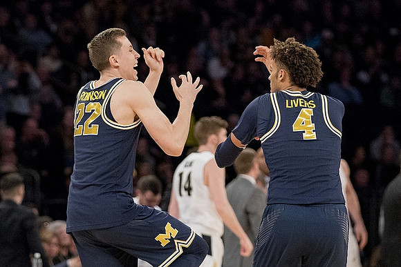 Duncan Robinson (22) and Isaiah Livers (4)